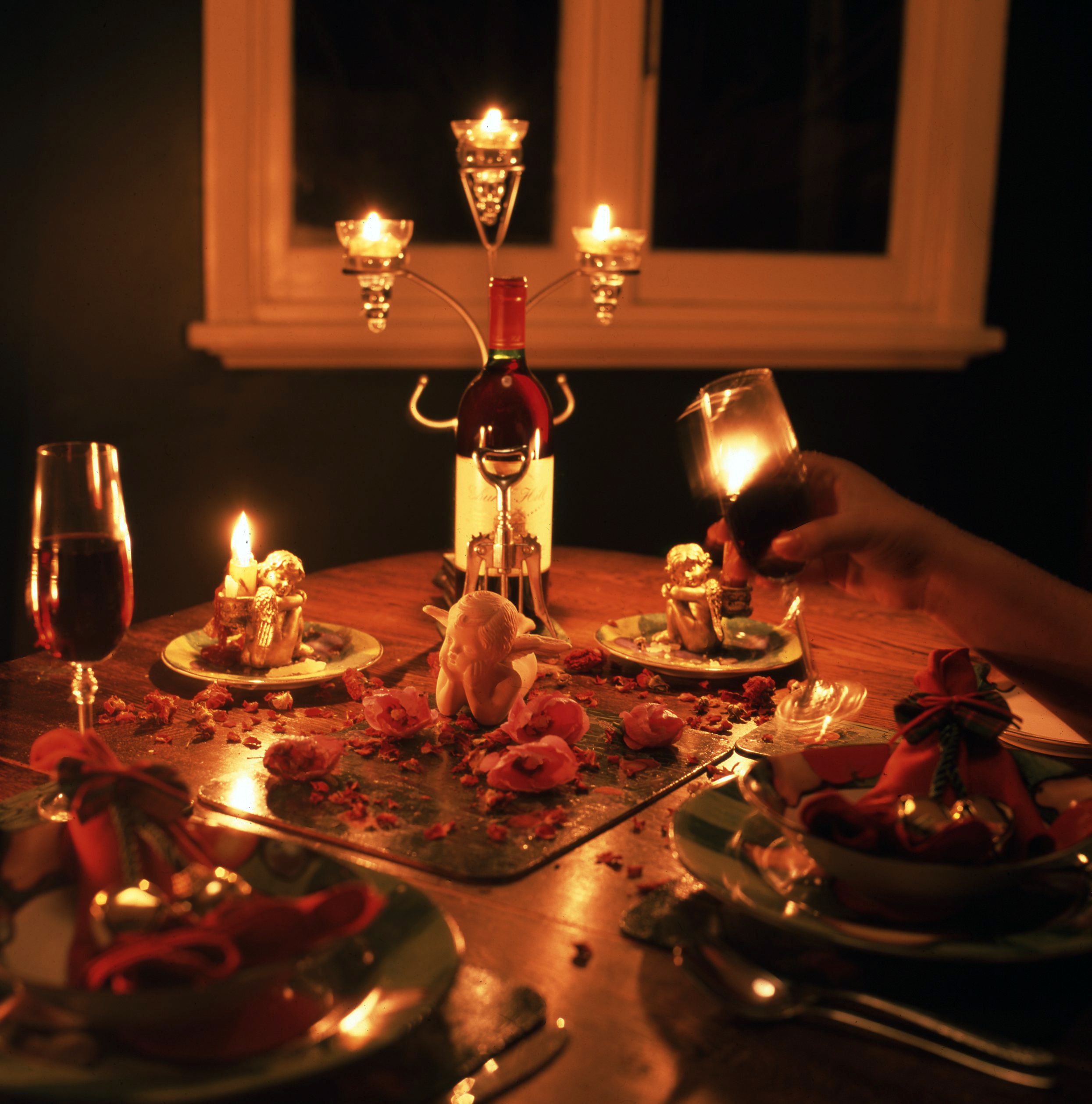 A glass on a candlelit table